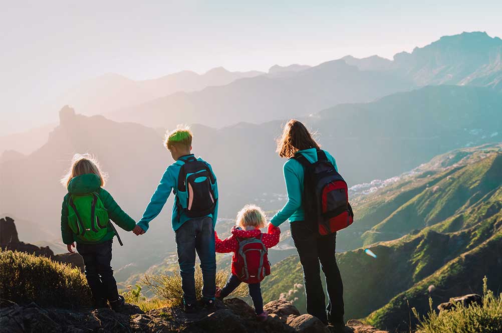 Mother with kids travel in mountains, family hiking in nature ...